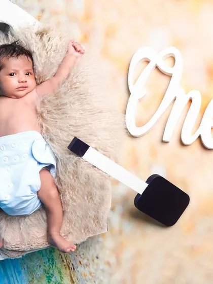 An awake baby enjoying the nautical-themed setup. This shot was taken during a one-month milestone session, showing we can capture great photos even with slightly older newborns.