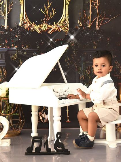 A handsome little pianist celebrating his second birthday. The classic piano setup is versatile and works beautifully for children of various ages.