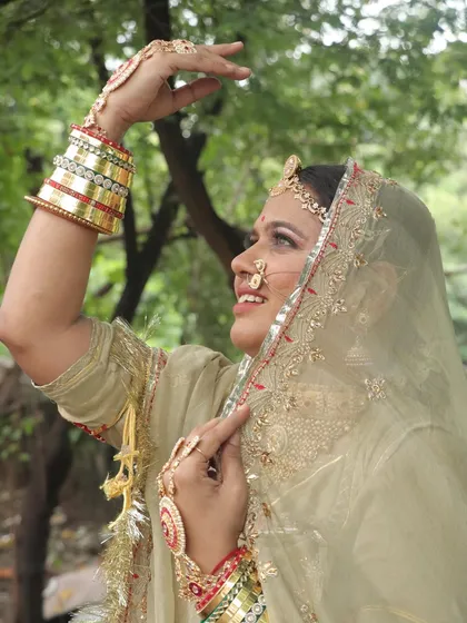 This image highlights the upward gaze and the beautiful details of the eye makeup and 'maang tikka'.