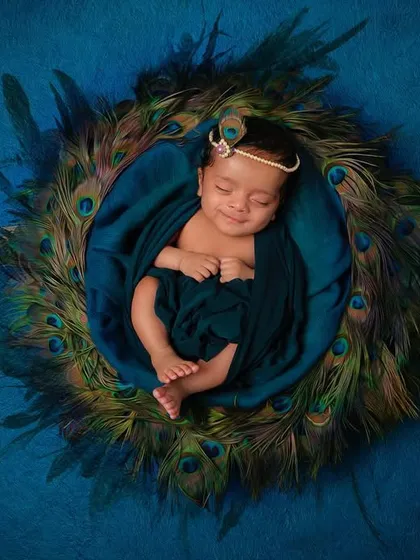 Our special 'Little Krishna' themed newborn shoot. We create a serene and beautiful setting with peacock feathers and soft fabrics to capture your little one as a divine 'natkhat Nandlal'.