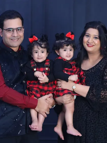 Another shot of this lovely family of four. Their smiles are infectious, and the classic studio setting ensures this portrait will be treasured for years.