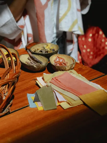 A beautiful flat-lay of our workshop setup, featuring bowls of natural dye materials and swatches of previously dyed fabrics. This gives participants a feel for the colors they can create.