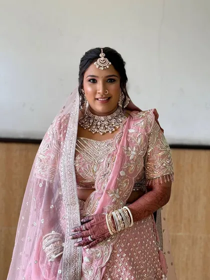 A full-length shot showing the bride's complete look. She looks confident and beautiful, ready for her big day.