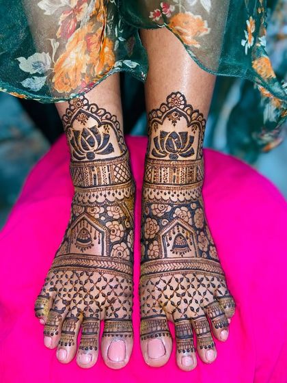 This foot design features large lotus motifs at the ankle, with the rest of the foot covered in a dense, traditional pattern.