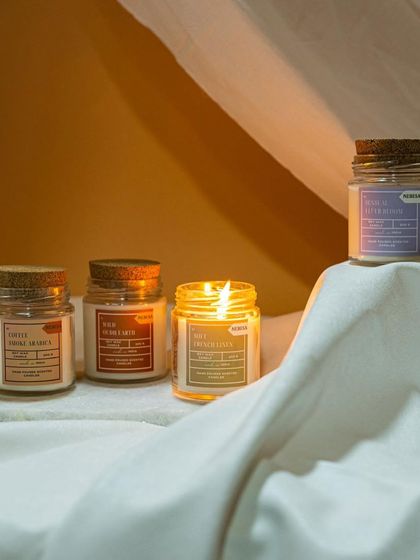This image captures the cozy ambiance my scented jar candles create. The warm light and soothing fragrance are perfect for a quiet evening at home. Here you can see a few of my different scents, each in its own unique jar.