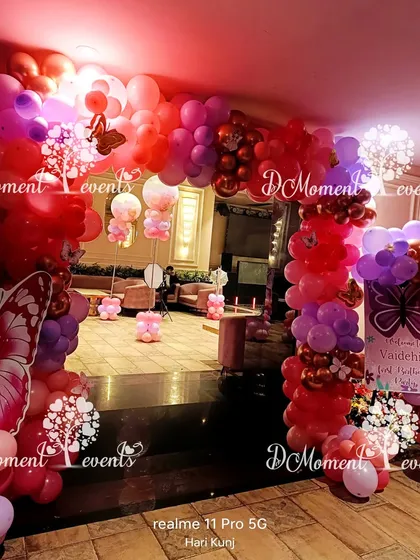 A closer view of the red and purple butterfly-themed entrance, showing the intricate balloon work and butterfly accents.