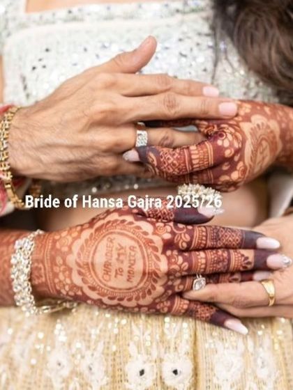 A touching moment between the bride and her mother. The bride's personalized mehendi is a beautiful detail in this emotional and loving embrace.