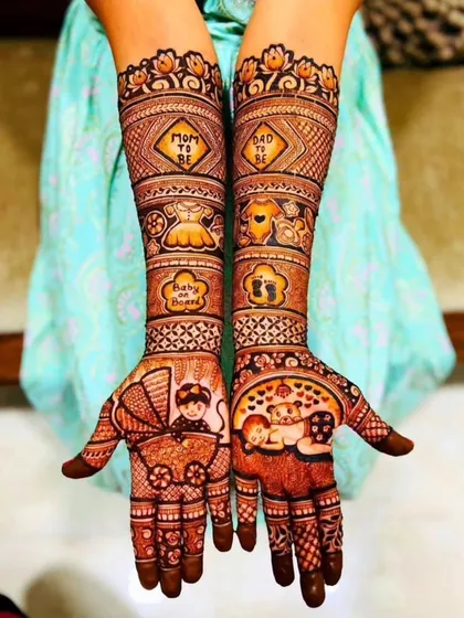 I love creating special designs for moms-to-be. This Godh Bharai or baby shower mehndi is filled with cute, celebratory details like a baby carriage, tiny clothes, and "Mom to be" messages to make the day unforgettable.