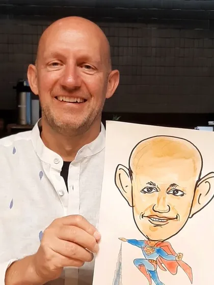 The joy is universal! This gentleman from the Google Cloud team was thrilled with his Superman caricature, a fun memento from the office event.