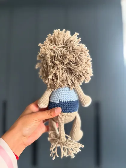 The back view of Toto the Lion, showing off his magnificent, fluffy mane and little tail.