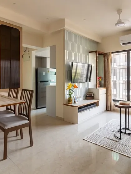 We specialize in smart solutions for city living. This custom-built unit features a fold-down dining table that seamlessly tucks away, transforming the living area and maximizing floor space in this modern Mumbai apartment.