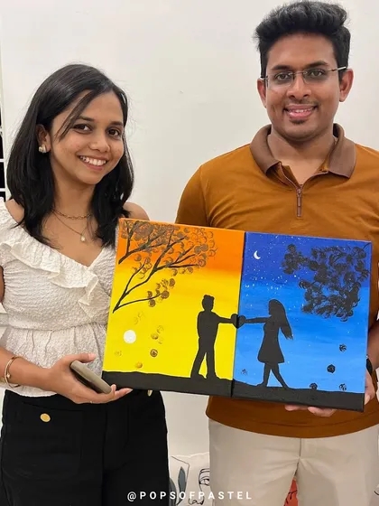 Art is the perfect date night. This happy couple is showing off their completed diptych painting, a two-part canvas that creates one beautiful picture. Our Sip and Paint sessions are a fantastic way to connect and create something meaningful together.
