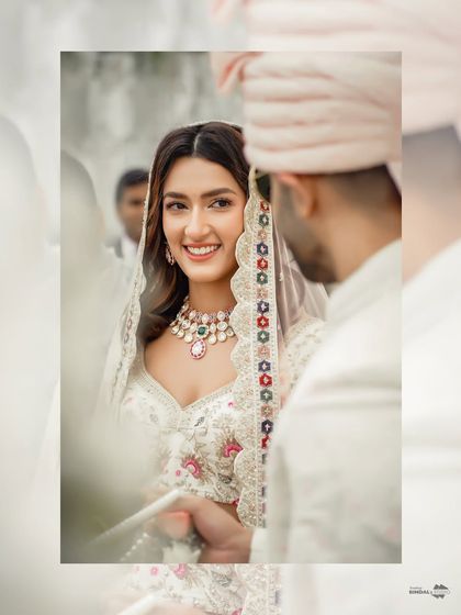 A beautiful, candid shot of the bride smiling at her groom during the ceremony. Her genuine happiness is the focus of this lovely portrait.