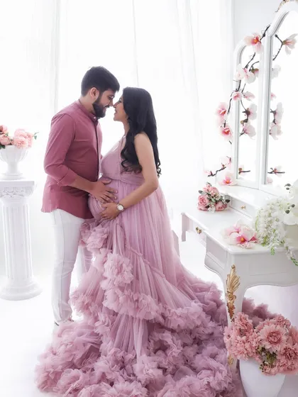 A romantic and intimate portrait. The couple's close embrace and shared gaze, surrounded by soft florals, create a timeless and love-filled image.