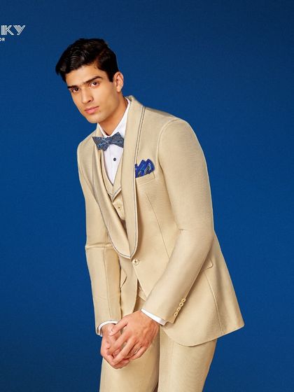 Elevate your style with this perfectly crafted beige three-piece tuxedo. The shawl collar and coordinated accessories make it ideal for a grand reception or a chic soirée.