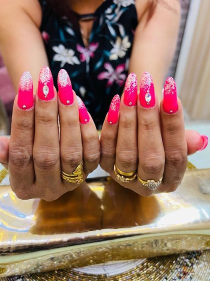 A head-on view of these dazzling pink and silver nails, showing off the symmetry and shine.