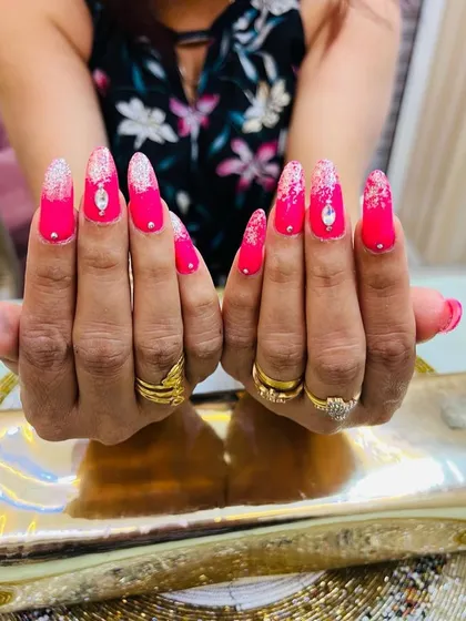 A head-on view of these dazzling pink and silver nails, showing off the symmetry and shine.