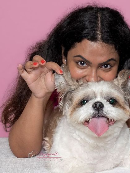 Goofy and fun! A pet parent joins her Shih Tzu for a playful pose during a studio session, showing that these shoots are for the humans too.