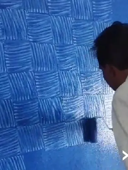 Here you can see our basket-weave texture technique in progress. We apply layers of paint with a specialized tool to create a woven, tactile effect that adds significant depth and character to a feature wall.