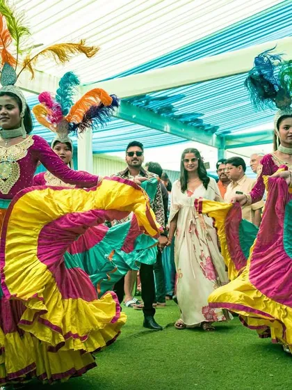 The couple walks hand-in-hand, surrounded by the energy of the carnival dancers. This image captures the festive and celebratory atmosphere I love to create.