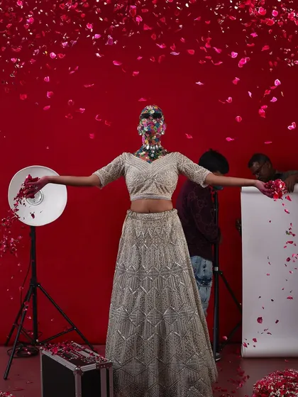 The "flower head" model in a shower of rose petals, a dramatic and beautiful shot from this highly creative portfolio shoot.