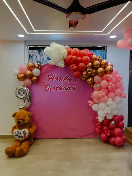 The main photo spot for the 9th birthday, featuring a pink backdrop, a large teddy bear, and a '9' foil balloon.