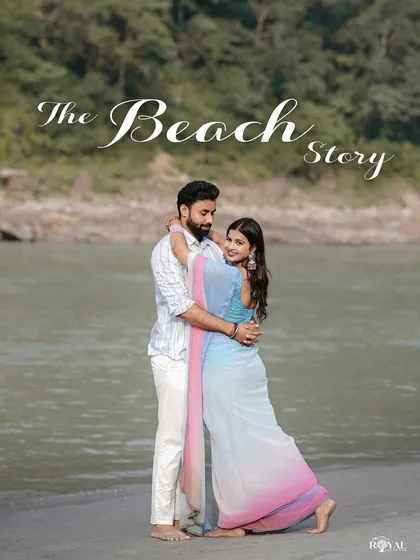 A romantic portrait of a couple embracing on the riverbank, titled 'The Beach Story'.