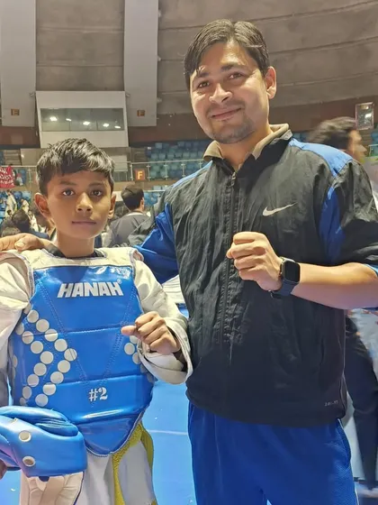 A young fighter ready to enter the ring at the Talkatora Indoor Stadium.