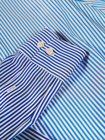 A classic blue and white striped shirt is a wardrobe staple. We use high-quality, breathable cotton to ensure it's as comfortable as it is stylish.