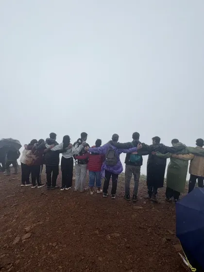 The group linked arm-in-arm, creating a human chain at the foggy summit of Nethravathi peak.