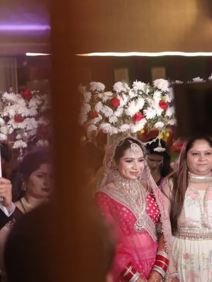 A beautiful bride making her entrance under the phoolon ki chadar. She is wearing a pink and silver lehenga rented from my collection.