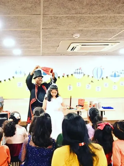 Performing a fun water trick with the birthday girl in front of her friends. My interactive magic show for kids is all about creating these memorable, hands-on experiences.