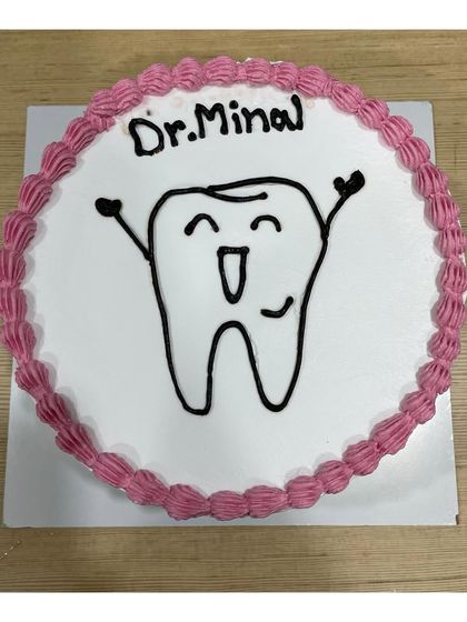 A cute blueberry-flavored cake for a dentist. The happy tooth drawing is a fun way to celebrate a birthday in the dental profession.