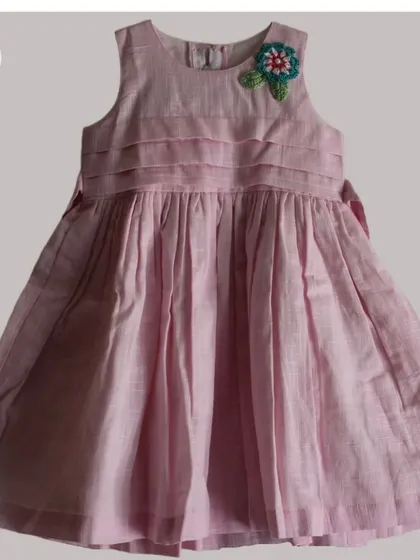 This detailed crochet flower patch, with its layers of color and leafy green base, is a perfect example of a statement appliqué for kids' clothing.