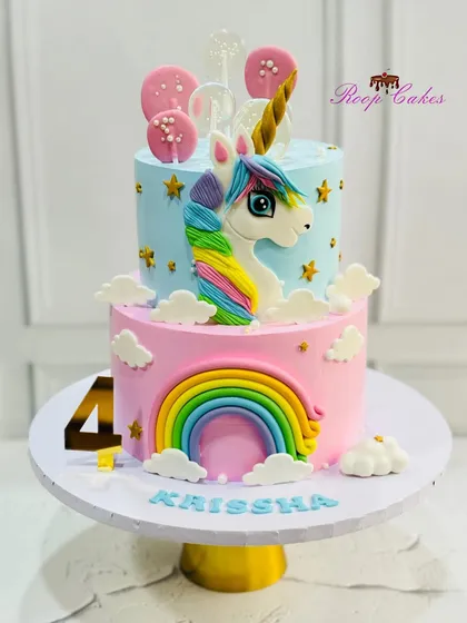 This two-tier unicorn cake was a dream to create for a magical 4th birthday. I handcrafted the fondant unicorn, rainbow, and clouds, and added shimmering stars and lollipops to complete this whimsical centerpiece.
