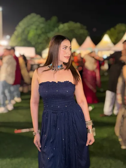 A candid shot in the navy blue Navratri outfit, showing how to style traditional jewelry with modern silhouettes.