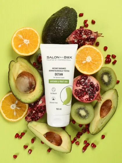 This is a styled flat lay photograph for the brand Salon in a Box. I arranged the product with its core ingredients like avocado, pomegranate, and orange to create a vibrant, colorful composition perfect for social media and e-commerce.