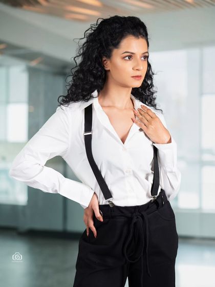 A confident pose in a modern business-casual look. The studio lighting is bright and even, creating a clean and accessible image suitable for commercial branding or a professional portfolio.