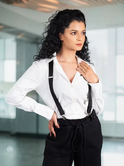 A confident pose in a modern business-casual look. The studio lighting is bright and even, creating a clean and accessible image suitable for commercial branding or a professional portfolio.