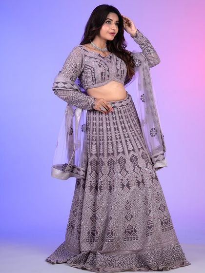 Another angle of the lilac lehenga, showing how the light catches the intricate mirror work. This outfit is designed to sparkle from every direction.