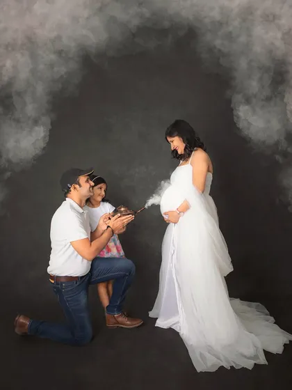 A creative and fun way to announce your baby's arrival. Here, the family uses a whimsical smoke effect from an old-fashioned lamp to reveal the magic of their growing family.