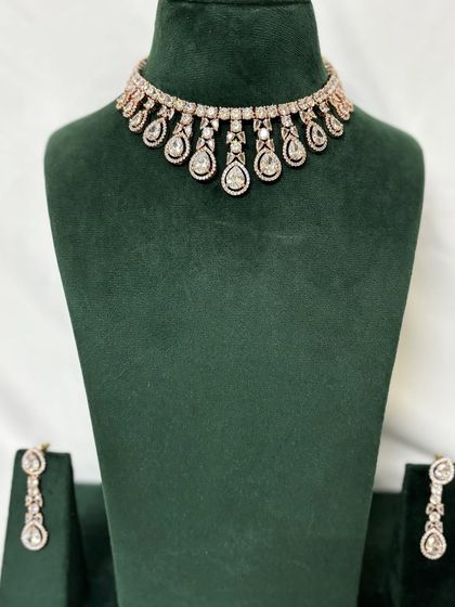 A full view of the rose-gold plated American diamond choker with matching earrings. A chic and modern rental option.