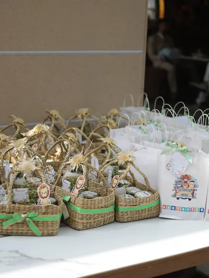 Themed return gifts for Aaryaveer's party, presented in charming wicker baskets and custom-printed bags.