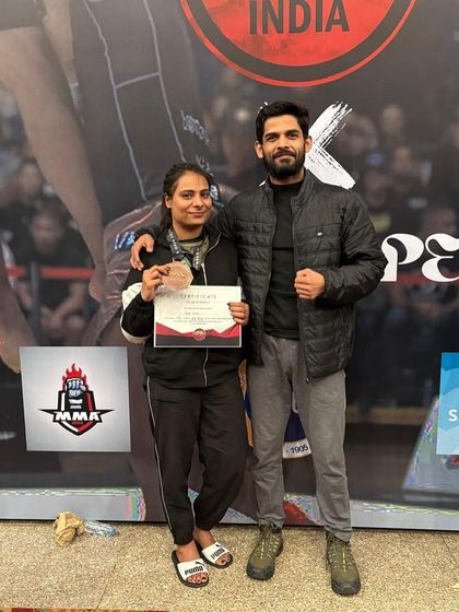 A proud coach with his student after she won a bronze medal at the ADCC Nationals. This is a result of her hard work and the team's support.