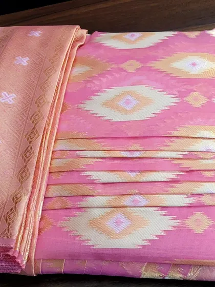 The full view of a pre-pleated and folded saree, ready for the client to take home.