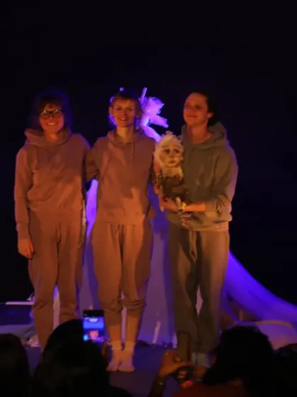 The cast of 'Sea of Possibilities' takes a bow with their beautiful puppet. Their casual costumes emphasize that they are creators and facilitators of the magic on stage.