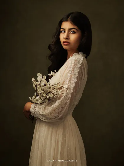 A closer look at this delicate portrait, focusing on her serene expression and the intricate details of the lace.