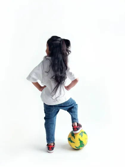 A pre-mundan shoot celebrating her beautiful long hair. This pose, with her foot on the ball, is full of confidence and sass.