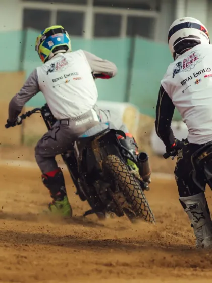 An action shot from the Slide School Cup, with dirt flying as riders slide their bikes through the corners.