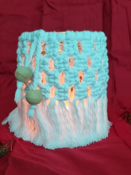 This two-tone jar cover creates a beautiful, cozy light when a candle is placed inside.